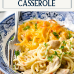 Fork in a bowl of chicken spaghetti casserole with text title box at top