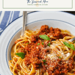 Bowl of homemade spaghetti meat sauce from a slow cooker with a text title box at the top