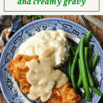 Overhead shot of a plate of fried chicken and gravy with text title box at the top