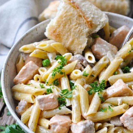 Penne pasta tossed in salmon cream sauce with a side of French baguette