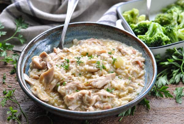 Horizontal shot of slow cooker chicken and rice with cream of mushroom soup on a wooden table