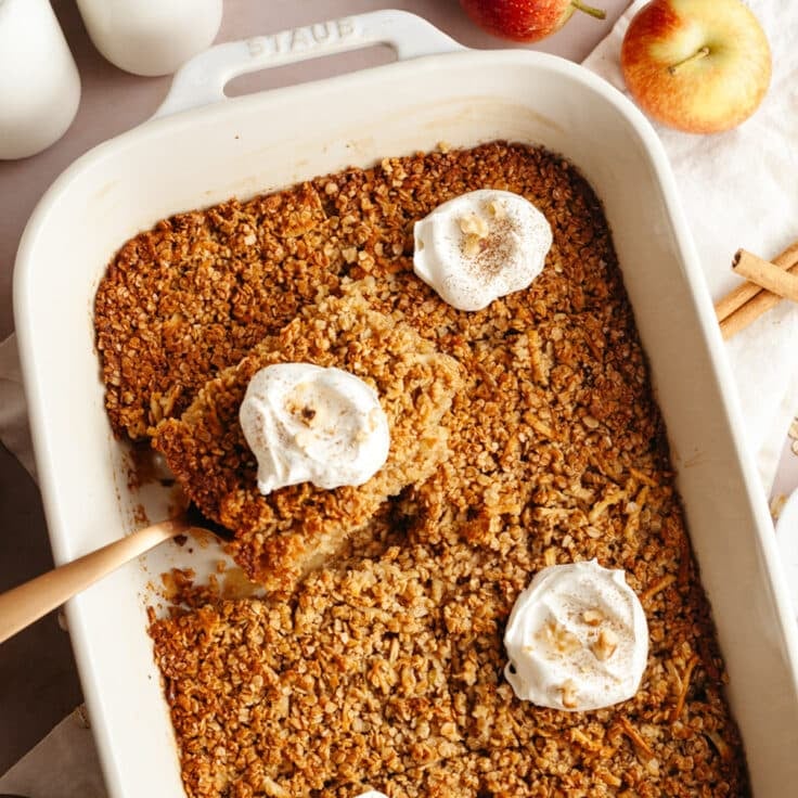 Square overhead shot of Amish style baked apple oatmeal in a white baking dish.