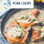 Side shot of a pan of stovetop pork chops with creamy mushroom sauce and text title box at top