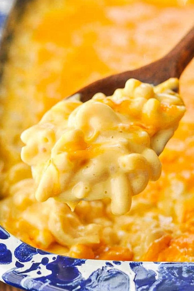 Creamy baked mac and cheese on a wooden serving spoon