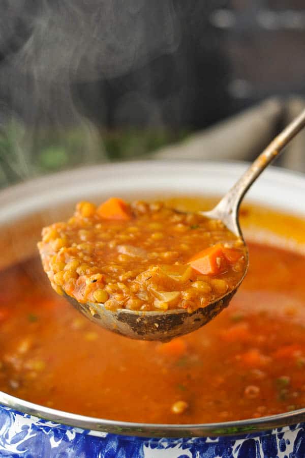 Steaming ladle full of the best lentil soup recipe