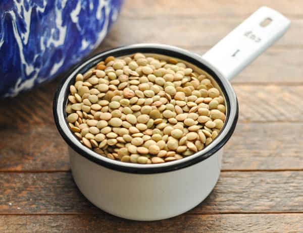 Dried lentils in a measuring cup