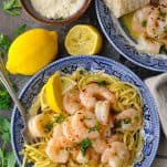 Overhead shot of shrimp scampi with pasta in a blue and white bowl