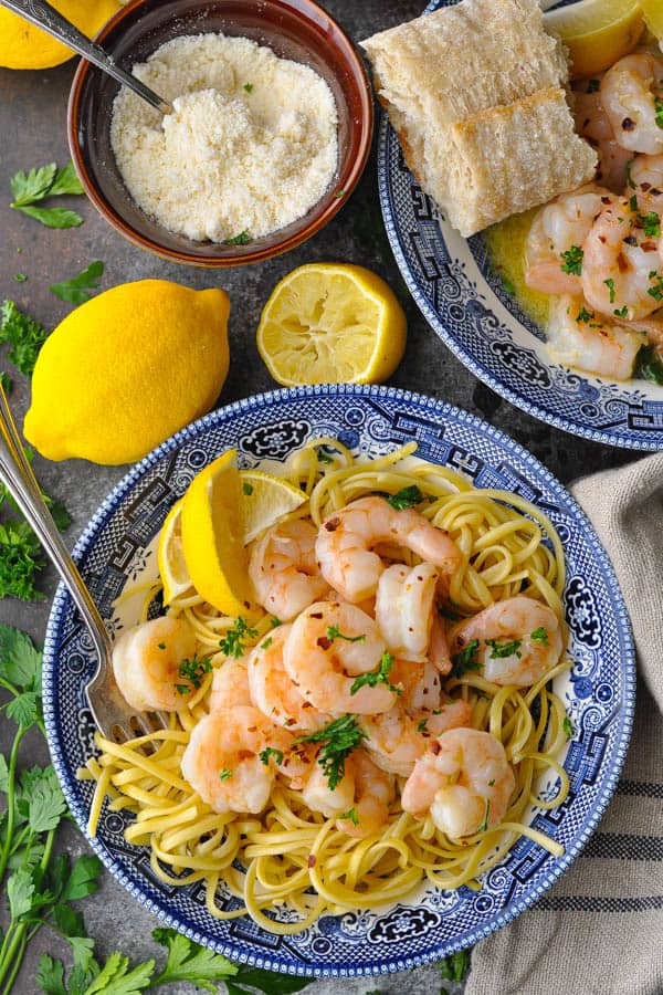 Overhead shot of shrimp scampi with pasta in a blue and white bowl