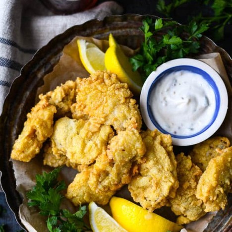 Close overhead image of cornmeal crusted fried oysters on a serving tray