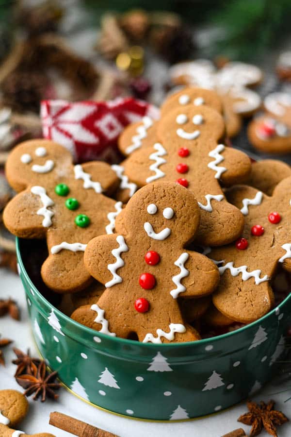 Soft gingerbread man cookies in a cookie tin with fun decorations and icing