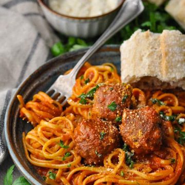 Homemade meatballs served in a bowl with spaghetti and sauce