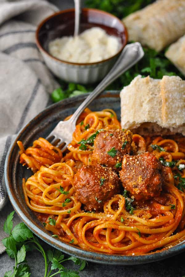Homemade meatballs served in a bowl with spaghetti and sauce