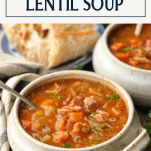 Side shot of a bowl of homemade lentil soup with a text title box at the top