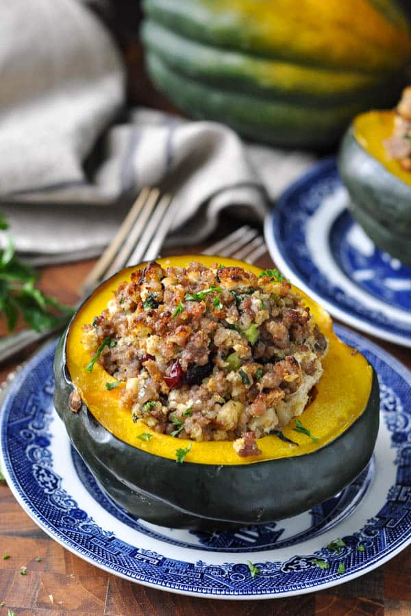 Front shot of sausage and spinach stuffed acorn squash on a plate