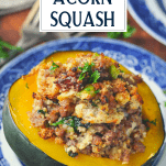Front shot of acorn squash on a plate with sausage stuffing and text title box at top