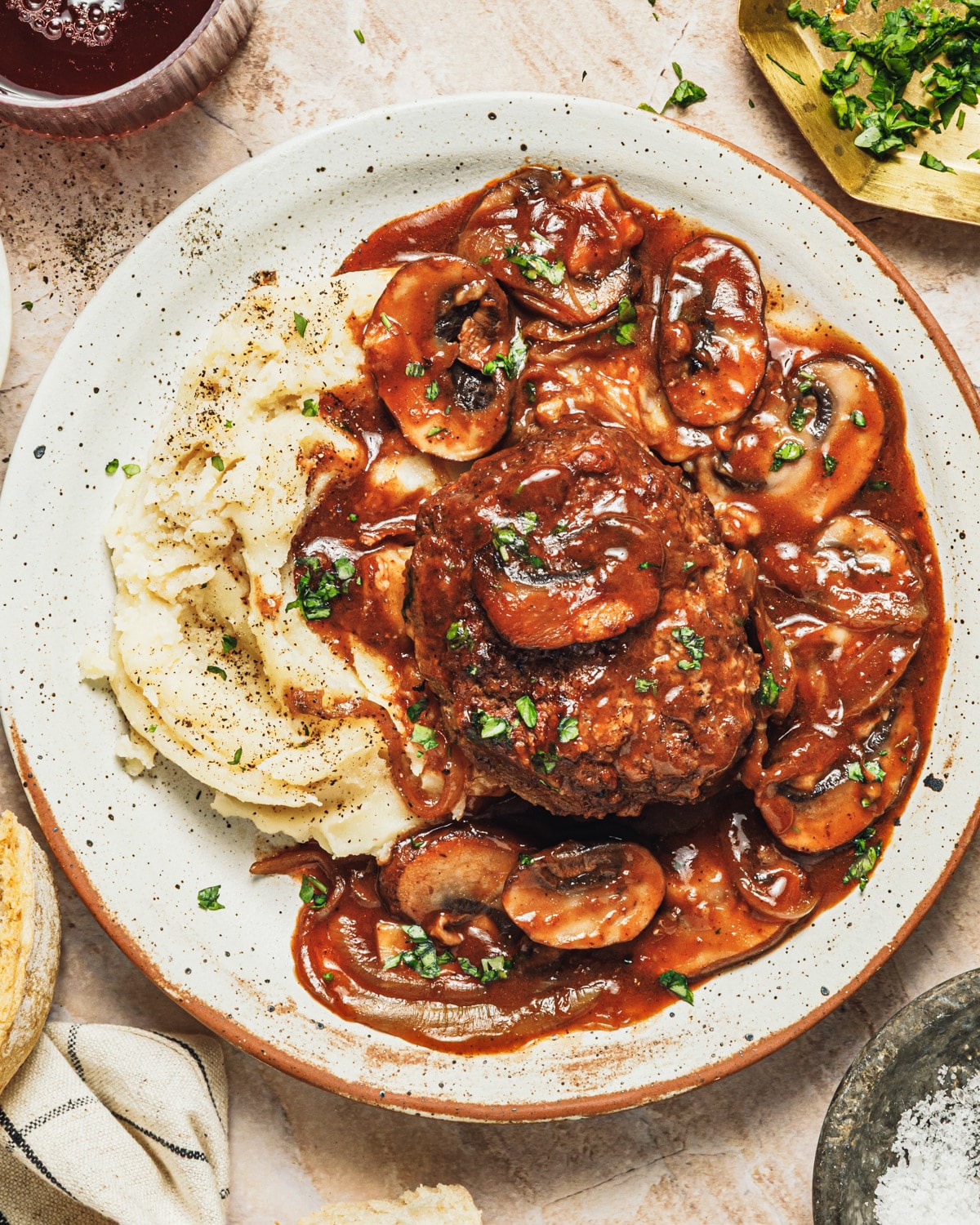 Homemade salisbury steak recipe served over mashed potatoes.