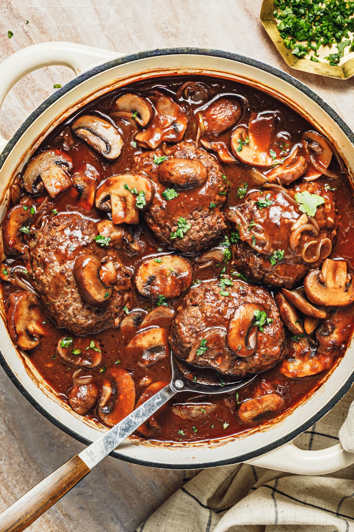 Close overhead shot of a pan of homemade Salisbury steak with mushroom gravy.