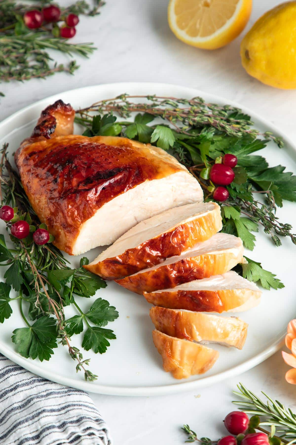 Side shot of maple glazed turkey breast on a plate.