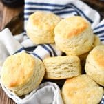 The best 3 ingredient biscuit recipe served in a bread basket with a blue and white striped towel