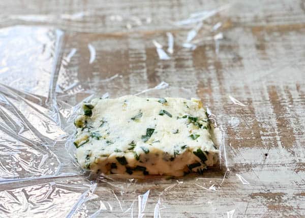Garlic and herb butter in plastic wrap