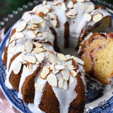 Close up overhead shot of a cranberry swirl coffee cake with a slice on a serving spatula