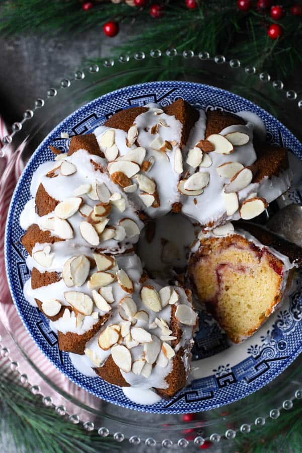 Close overhead image of a cranberry coffee cake on a blue and white platter