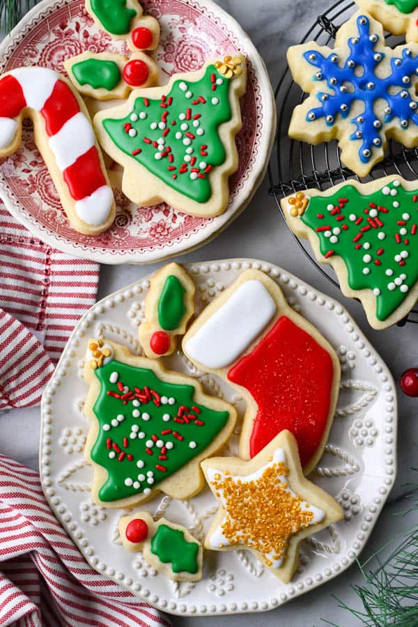Overhead image of soft sugar cookies decorated with frosting and served on a white plate