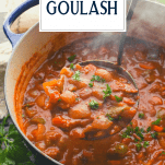 Ladle full of Hungarian beef goulash with text title overlay