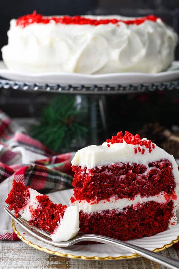 Close up front shot of a slice of an easy red velvet cake recipe with a bite on a fork