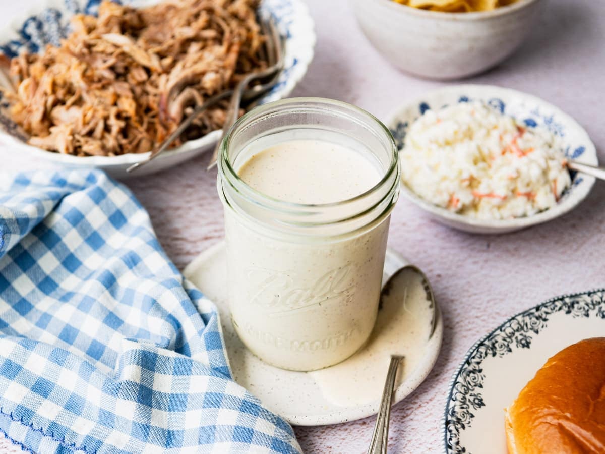 Horizontal side shot of Alabama white bbq sauce in a mason jar.