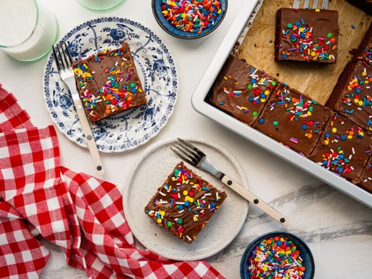 Overhead shot of slices of Texas sheet cake on plates.