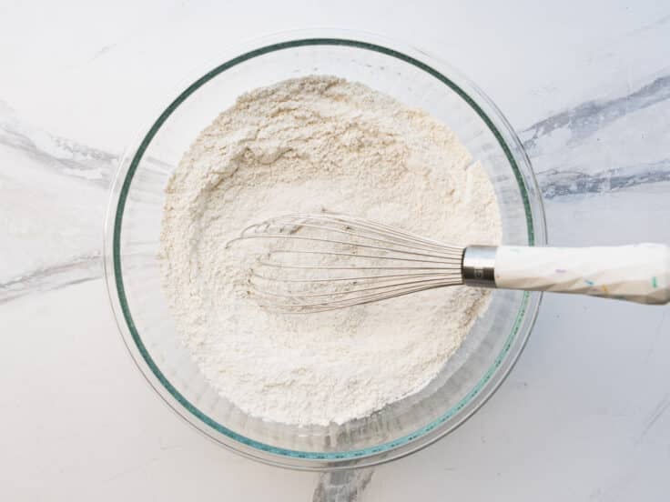 Whisking the dry ingredients in a glass bowl.