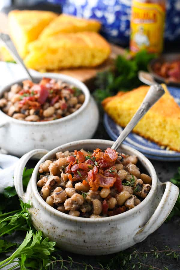 Front shot of an easy black eyed peas recipe served in small bowls and topped with bacon