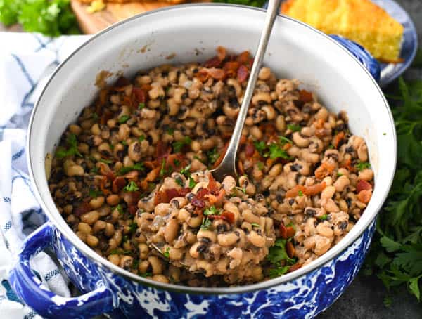 Horizontal shot of black eyed peas with bacon in a blue and white pot