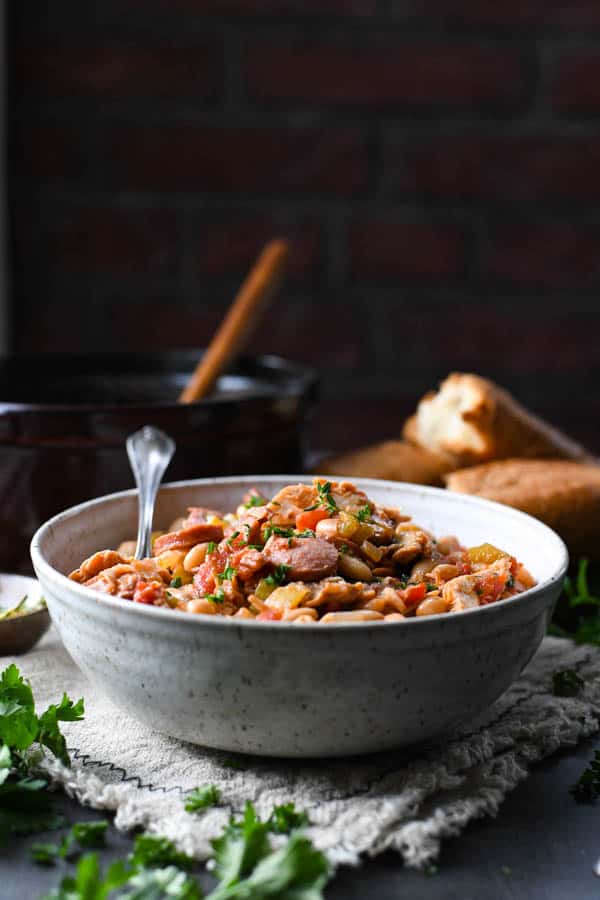 Front shot of easy cassoulet recipe on a table in front of a dark background