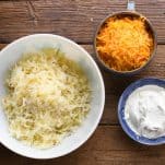 Ingredients for potato casserole with shredded potatoes cheese and sour cream