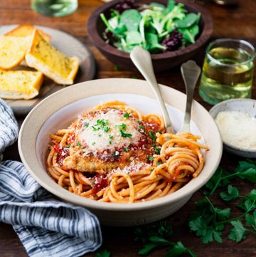 Square side shot of a bowl of pasta with the best easy chicken parmesan recipe