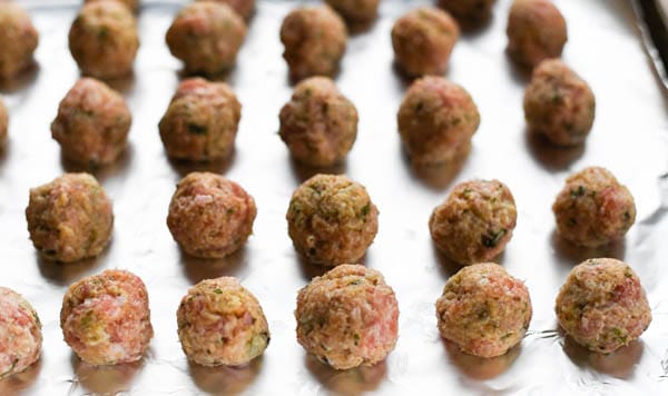 Raw chicken meatballs on a tray