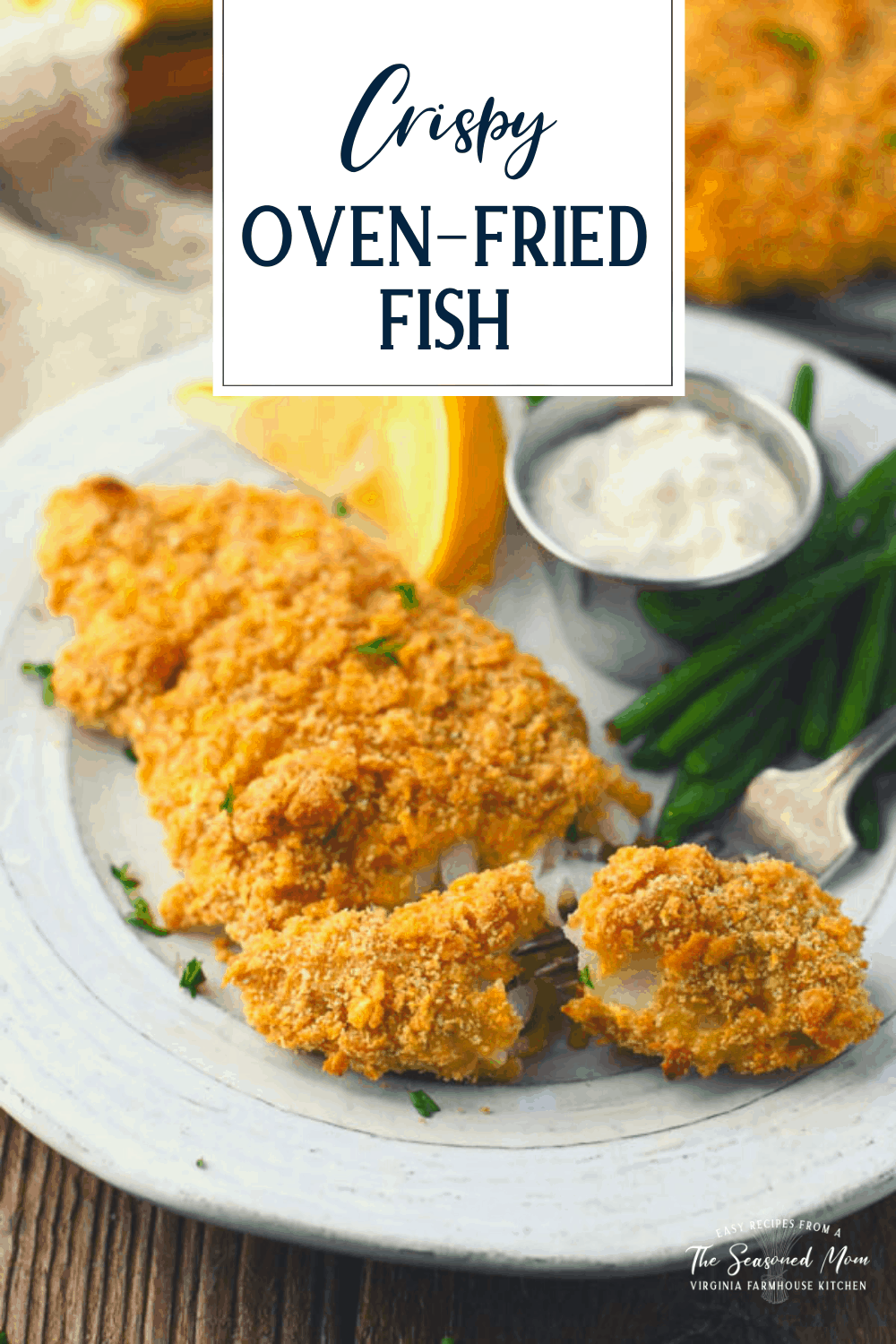Crispy oven fried fish on a white plate with text title overlay