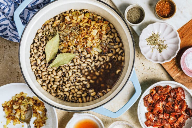 Process shot showing how to make a classic Southern black eyed peas recipe with bacon.