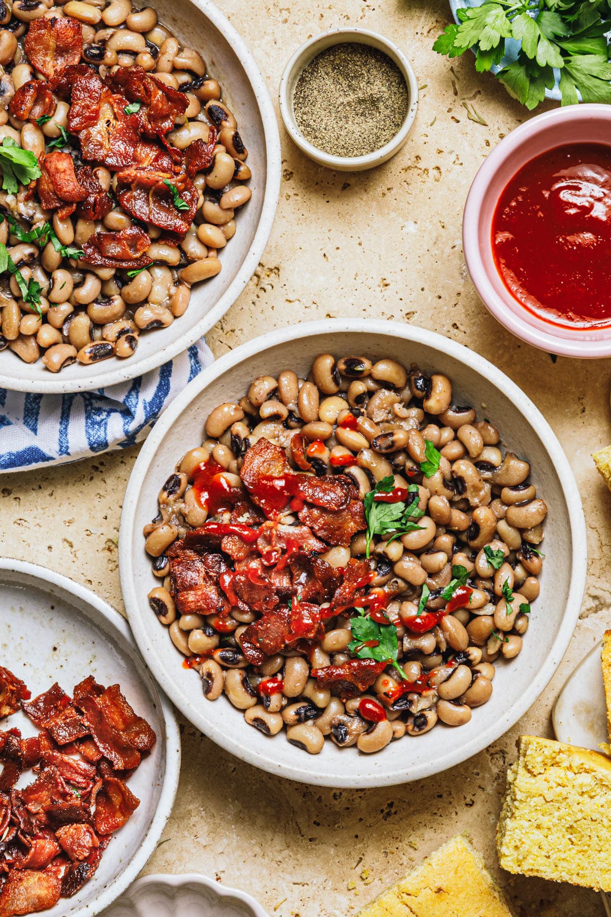 Overhead image of black eyed peas with bacon on a table.