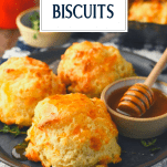 Plate of homemade cheese biscuits with text title box at top