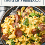 Close overhead shot of a bowl of skillet mac and cheese with sausage and a text title box at top