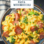 Close overhead shot of a bowl of smoked sausage and pasta with text title overlay