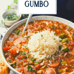 Close up side shot of a bowl of Louisiana chicken and sausage gumbo with text title overlay
