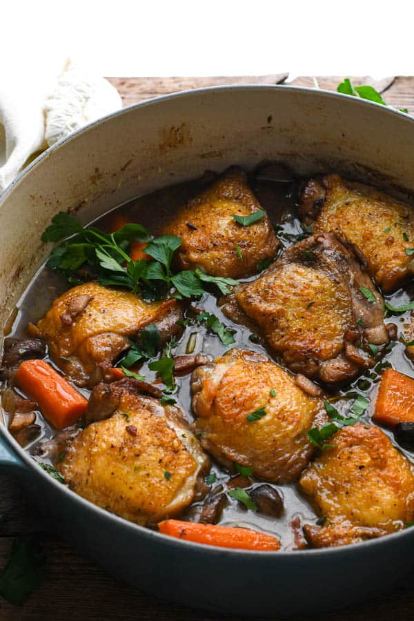 A classic French chicken stew in a Dutch oven