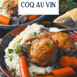 Side shot of coq au vin with mashed potatoes and text title overlay