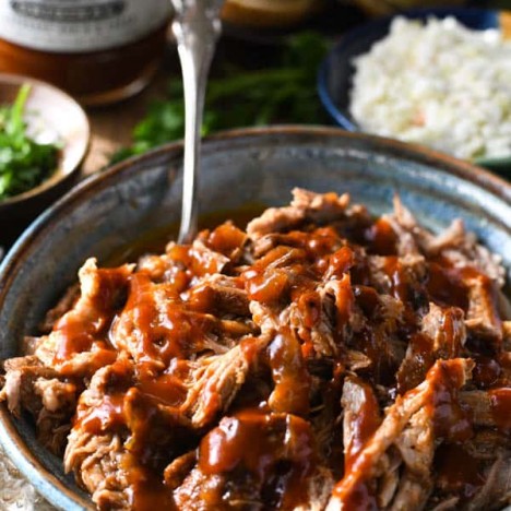 Close up side shot of dr pepper barbecue pulled pork in a bowl
