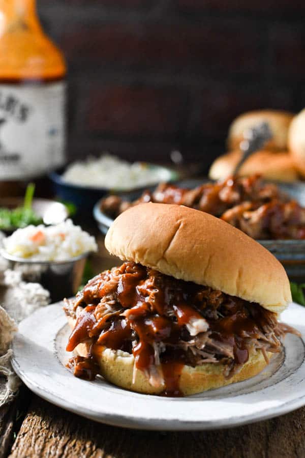 Front shot of dr pepper pulled pork sandwiches on a white plate