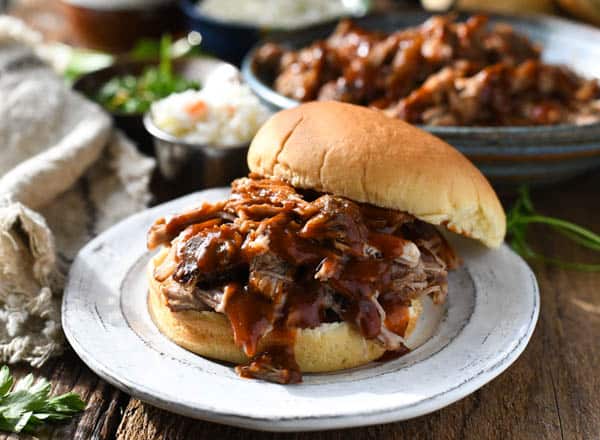 Horizontal shot of dr pepper pulled pork sandwich on a plate